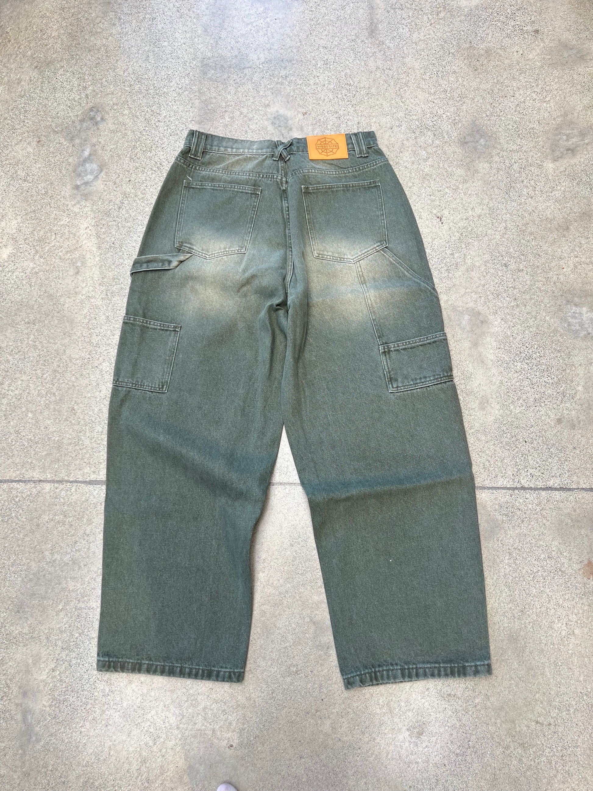 Webstate green double knee jeans on skater - functional reinforced skate denim